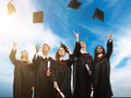 Graduated students throwing hats in the air Royalty Free Stock Photo