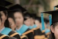 Graduates in commencement graduation ceremony row, metaphor educ