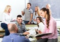 Graduates consulting with lecturer