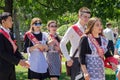 Graduates in festive school uniform in a city park