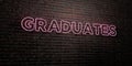 GRADUATES -Realistic Neon Sign on Brick Wall background - 3D rendered royalty free stock image