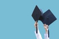 Graduates student Graduation caps thrown on a blue isolated