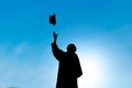 Graduates throwing hat on graduation day, silhouette Royalty Free Stock Photo