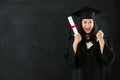 Graduating student gesturing fist cheerful