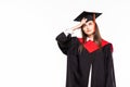 Graduating student girl in an academic gown isolated over white background Royalty Free Stock Photo