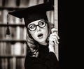 Graduating student girl in an academic gown near blackboard Royalty Free Stock Photo
