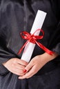 Graduating student holding her diploma Royalty Free Stock Photo