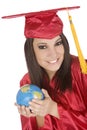 Caucasian student wearing a red graduation gown and holding globe
