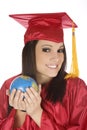 Caucasian student wearing a red graduation gown and holding globe