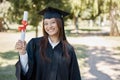 Graduation award, university and portrait of girl on campus with smile for success, diploma and achievement. Education