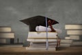 Graduation cap above stack books with degree paper Royalty Free Stock Photo