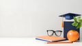 Graduation cap, books, glasses, apple, pencil, education, study, academic Royalty Free Stock Photo