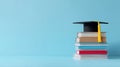 Graduation Cap on Colorful Books Stack Minimalist Education Background Conceptual Image for Academic Achievement and Knowledge Royalty Free Stock Photo