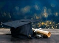 graduation cap, hat with degree paper on wood table, abstract li