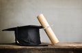 graduation cap, hat with degree paper on wood table Empty ready Royalty Free Stock Photo