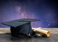 graduation cap, hat with degree paper on wood table, milky way b