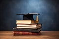 Graduation cap on stack of books on wooden table. Education concept, Book stack with a graduation hat on top of the books with Royalty Free Stock Photo