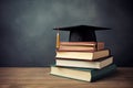 Graduation cap on stack of books on wooden table over blackboard background, Book stack with a graduation hat on top of the books Royalty Free Stock Photo