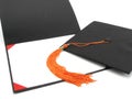 Graduation cap, tassel, and empty diploma frame Royalty Free Stock Photo