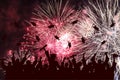 Graduation ceremony, fireworks in night sky. Silhouette of happy graduate students throwing academic square caps Royalty Free Stock Photo