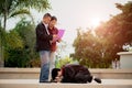 Graduation ceremony. Young female graduate giving graduation certificate to her parent at the university Royalty Free Stock Photo