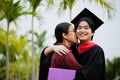 Graduation ceremony. Young female graduate hugging each other with her mother congratulate the student at the university Royalty Free Stock Photo