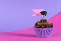 Graduation day pink and purple party cupcake with copy space. Royalty Free Stock Photo