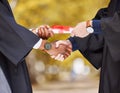 Graduation diploma, handshake and student in success, achievement and congratulations or thank you. Graduate or Royalty Free Stock Photo