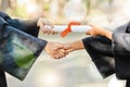 Graduation diploma, university and people shaking hands for learning success, education development or graduate scroll