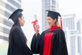 Graduation Friend Celebrate Degree Concept. Happy students with diplomas outdoors. Graduation ceremony Royalty Free Stock Photo