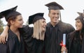 Graduation, friends and diversity of students hug to celebrate success, college event and smile. Happy group, graduates