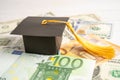 Graduation gap hat on US dollar and EURO banknotes money, Education study fee learning teach concept