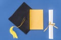 Graduation hat with diploma and book Royalty Free Stock Photo