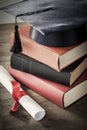 Graduation hat and diploma with book on table Royalty Free Stock Photo