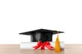 Graduation hat and diploma on table Royalty Free Stock Photo