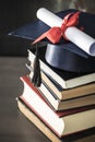 Graduation hat and diploma on table Royalty Free Stock Photo