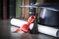 Graduation hat and diploma on table Royalty Free Stock Photo