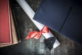 Graduation hat and diploma on table Royalty Free Stock Photo