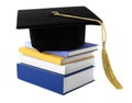 Graduation hat with gold tassel and stack of books Royalty Free Stock Photo