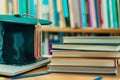 graduation Hat off student on stack of books, laptop, library background. Education learning concept Royalty Free Stock Photo