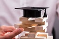 Graduation Hat Over Stacked Wooden Blocks
