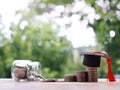 Graduation hat on stack of coins. The concept of saving money for education, student loan, scholarship, tuition fees in future Royalty Free Stock Photo