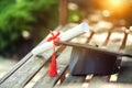 Graduation hat with tassel, diploma with red