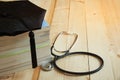 Graduation hat on the textbooks and a stethoscope on wooden background