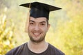 Graduation man portrait smiling and looking hap Royalty Free Stock Photo