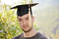 Graduation man portrait smiling and looking hap Royalty Free Stock Photo