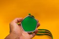 Graduation medal with green and yellow ribbons on white background