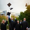 Graduation, mortar in air and student friends outdoor on campus for celebration at university ceremony. Education Royalty Free Stock Photo