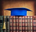 Graduation mortarboard on top of stack of books