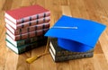 Graduation mortarboard on top of stack of books Royalty Free Stock Photo